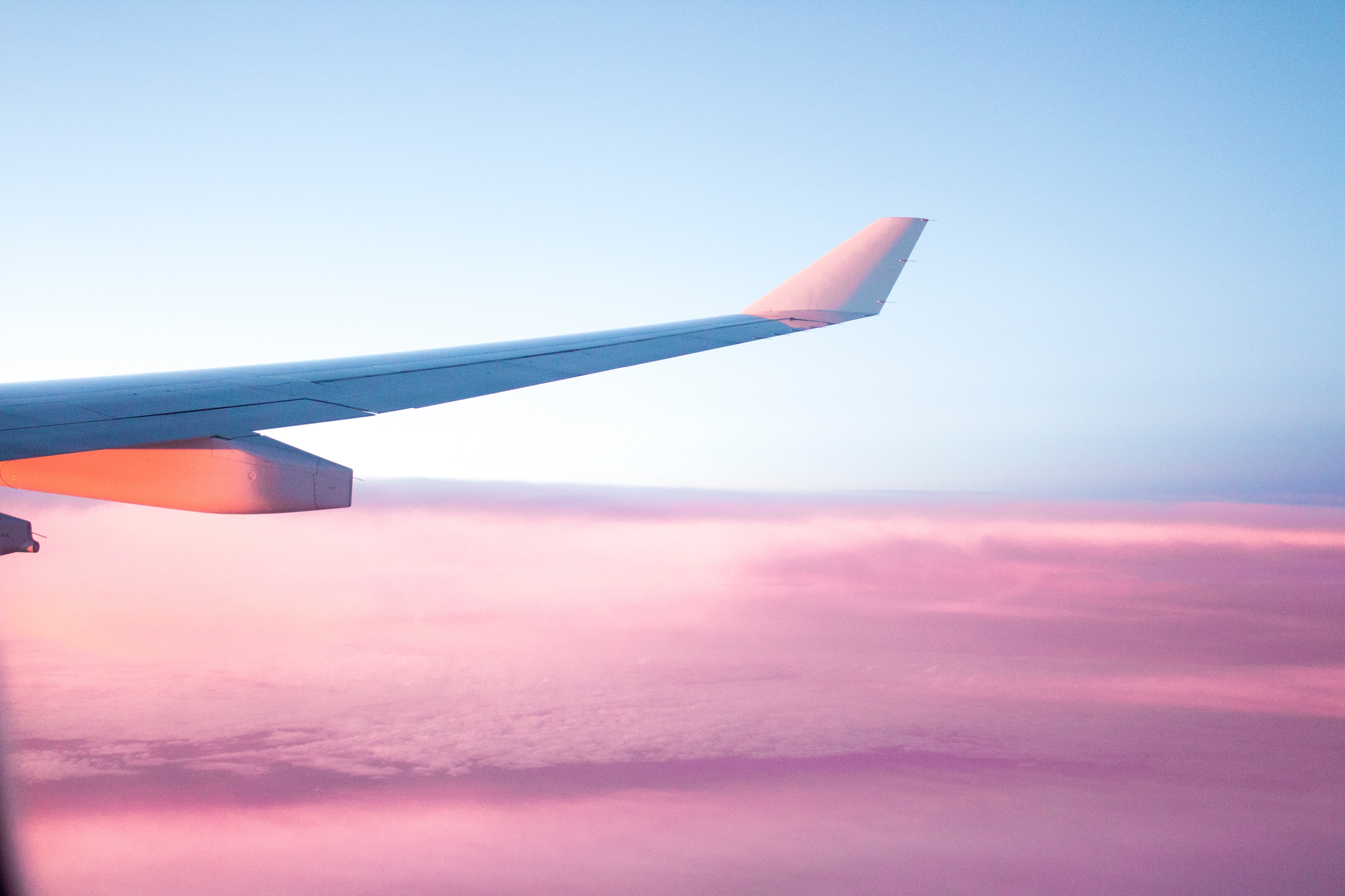 Airplane wing over clouds.